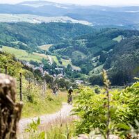Biker beim Anstieg vor toller Mittelgebirgskulisse