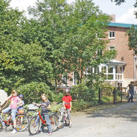 Einfahrt der Wassermühle Malstedt mit mehreren Radfahrern